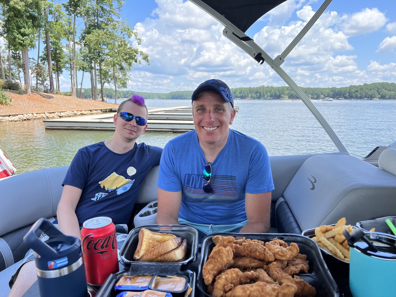 Myke and James sitting on a boat.