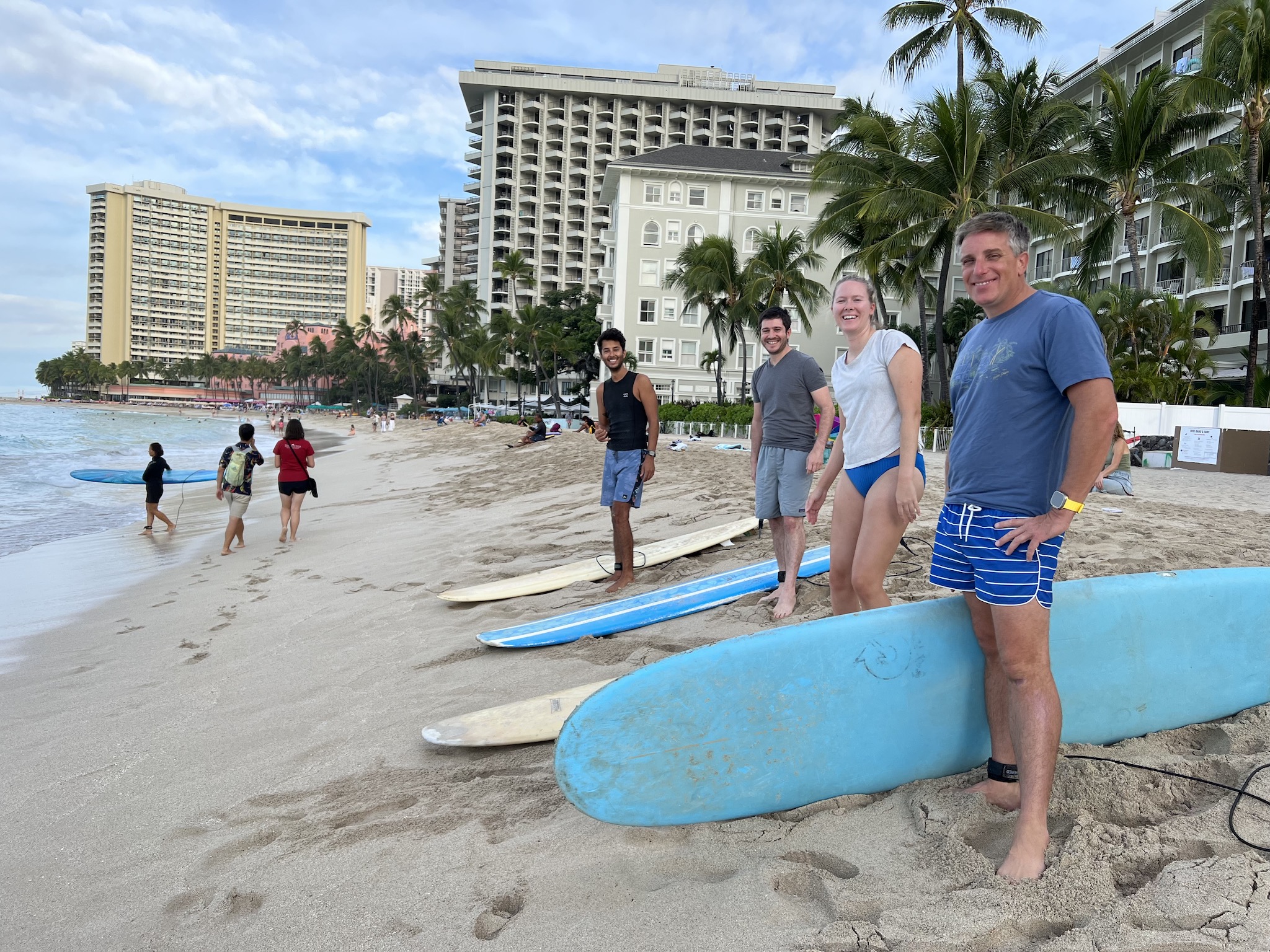 A group of people with surf boards on a beach.