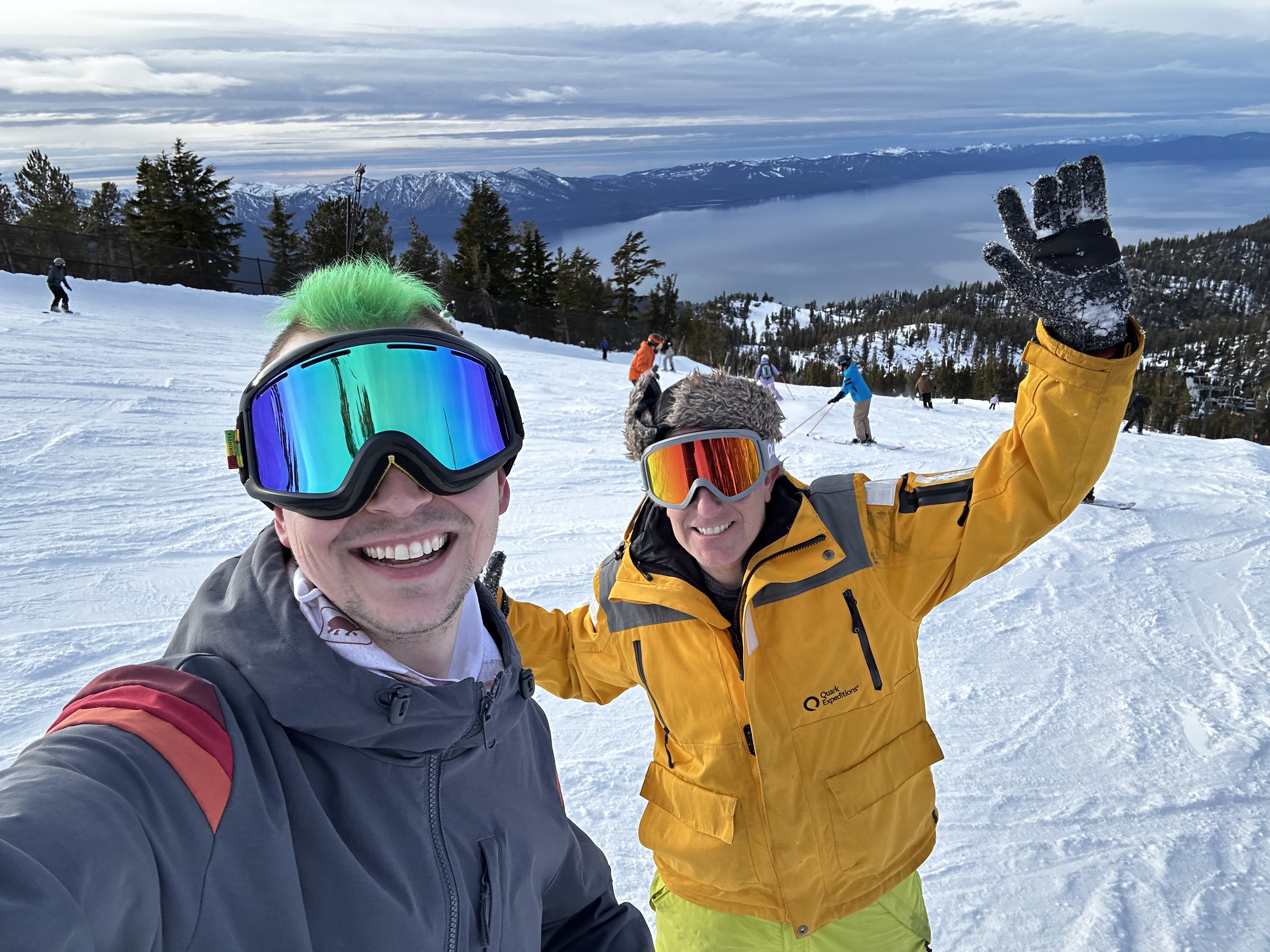 Two people posing for a selfie on a ski slope